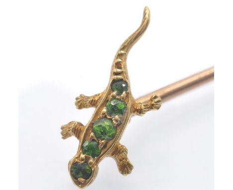 An antique gold and demantoid garnet salamander stick pin. The pin surmounted by salamander set with mixed cut demantoid garn