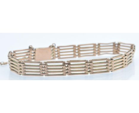 A 9ct rose gold five bar gate link chain bracelet. The bracelet formed of articulating five bar gate links united by button c