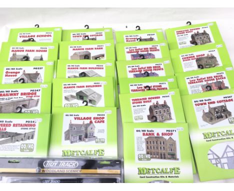 A collection of Metcalfe Card Construction kits all unopened in 00 scale. Includes Bank ..shop..farm building..railway bridge