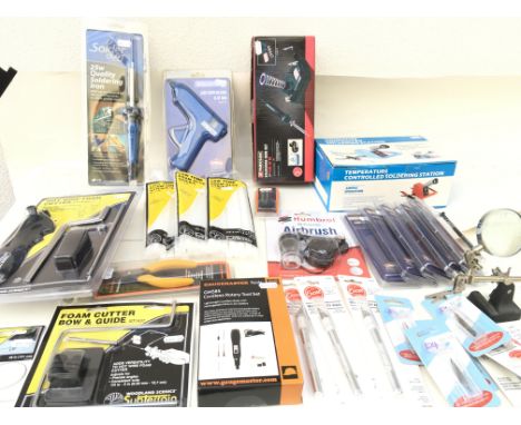 A collection of new and unopened tools used for modelling..including soldering irons..hot glue gun with glue..Airbrush..Foam 