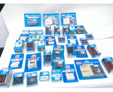 A collection in excess of 35 new unopened PECO Lineside kits in 00 scale . Includes weighing machine..bookstall..subway stair