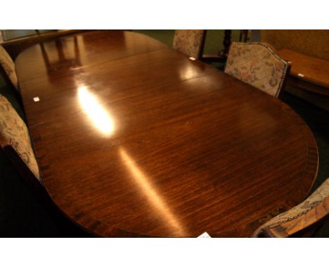 Regency-style mahogany extending dining table with brass inlay and an extra leaf, which extends to approximately 212cm long. 