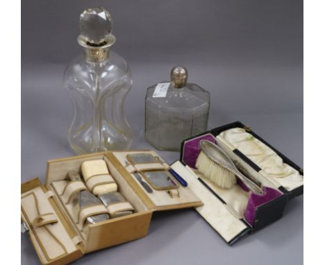 A silver collared glass decanter (af) and one other decanter, a vanity case and cased silver brush & comb.