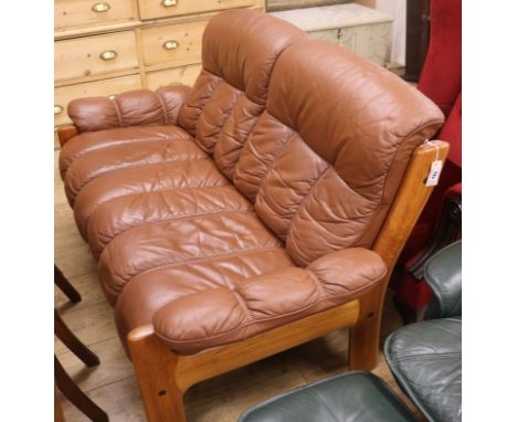 A brown leather two seater Scandinavian sofa