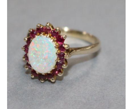 A 9ct gold, white opal and ruby oval cluster ring, size Q.