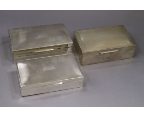 Three assorted engine turned silver cigarette boxes, largest 15.4cm.