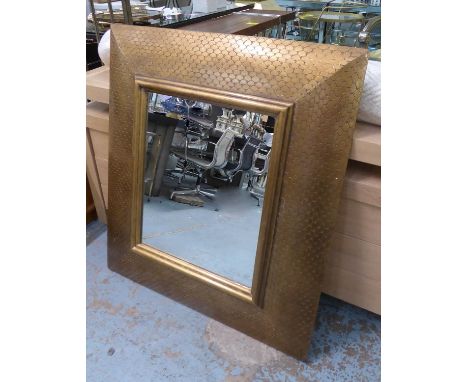 WALL MIRROR, with a gilt frame in a fish scale pattern, 92cm x 105cm. 