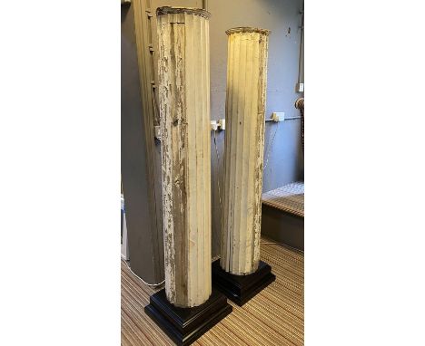 COLUMNS, a pair, 19th century fluted pine of large scale in distressed painted finish on later ebonised plinth bases, 183cm H