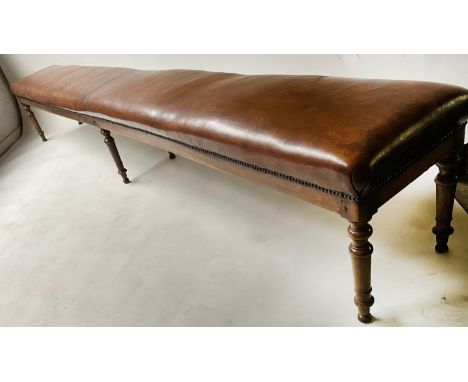 COUNTRY HOUSE HALL BENCH, early 19th century English of exceptional length in close nailed brown leather on six turned taperi