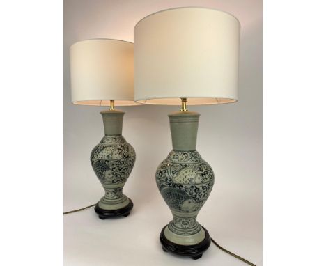 TABLE LAMPS, a pair, Chinese blue and white ceramic vase form decorated with fish, with carved hardwood bases and shades, 65c