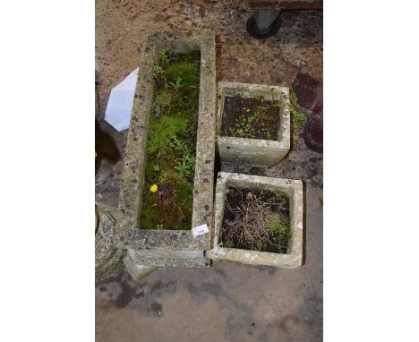 A composite trough planter together with two smaller planters