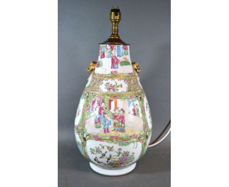 A 19th Century Canton Large Table Lamp decorated in polychrome enamels with figures amongst foliage and with gilded lion ring