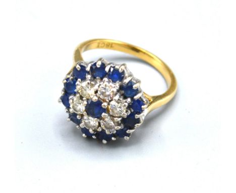 An 18ct Gold Diamond and Sapphire Cluster Tiered Ring, claw set, Ring size O, 8.4grams 