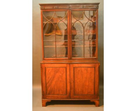 A 19th Century Mahogany Bookcase, the moulded cornice above two astragal glazed doors enclosing shelves, the lower section wi