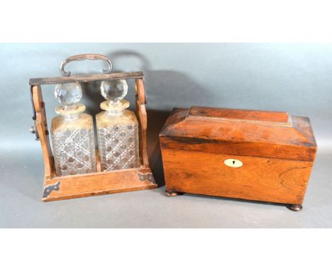 An Oak And Silver Plated Tantalus with two cut glass decanters together with a 19th Century sarcophagus shaped tea caddy 