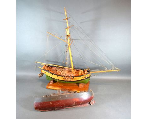 A Metal Model Of A Battleship by Sutcliffe together with a model in the form of an RN Cutter 