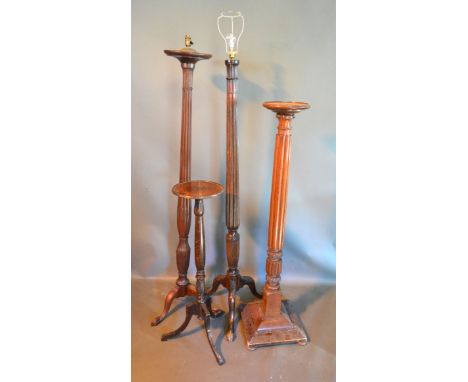 A Mahogany Lamp Standard with a reeded column together with another similar and two mahogany torcheres 