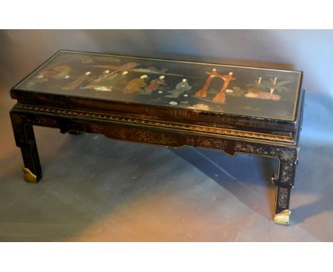 A Japanese Lacquered Low Table of rectangular form, the top inset various hard stone depicting figures within a landscape and