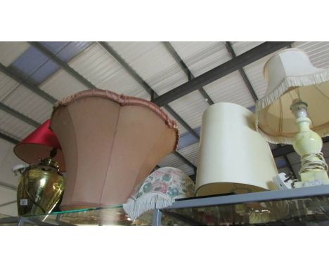 A large brass table lamp, other lamps and lamp shades.