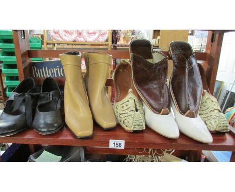 A shelf of vintage boots and shoes,