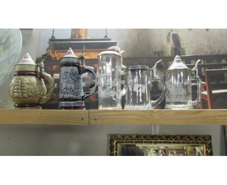 3 glass beer steins and 2 ceramic beer steins.