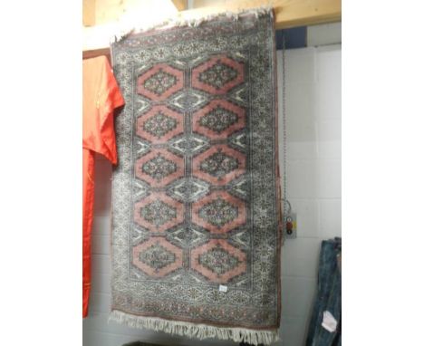 A silk rug, damage to one side.