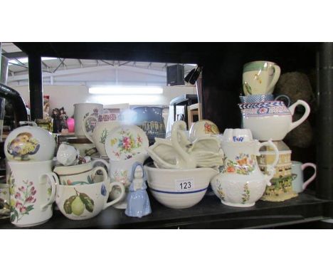 A shelf of assorted ceramics including jugs, dishes etc.,