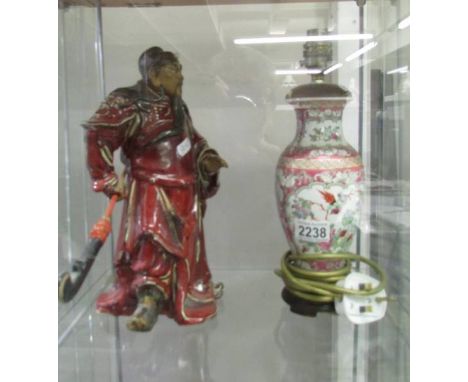 A Chinese figure and a Chinese lamp base.