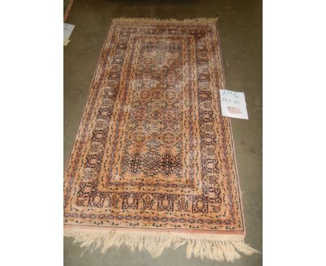 A 112 x 84 cm rug.