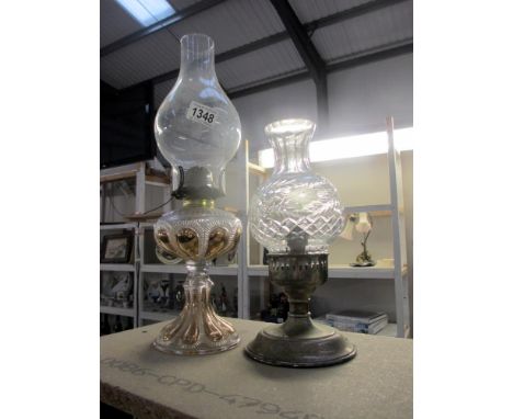 A silver plated candle lamp and a gilded glass oil lamp