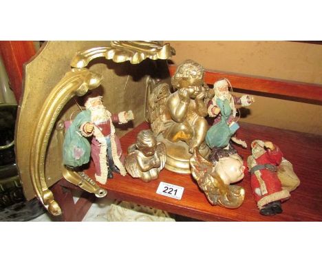 A gilded shelf bracket, 3 cherubs and 3 vintage Santa figures.