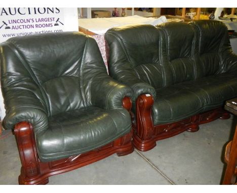 A green leather 3 seat sofa and chair with dark wood frames.