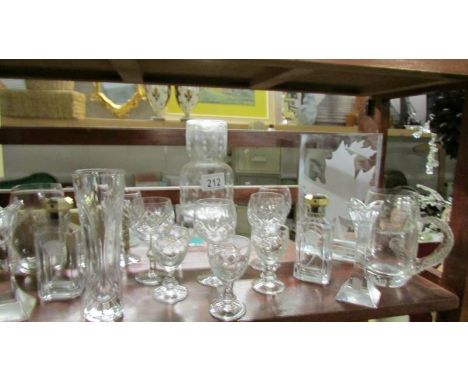 A shelf of glass ware including scent bottles.