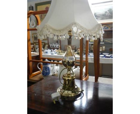 A brass effect table lamp with shade