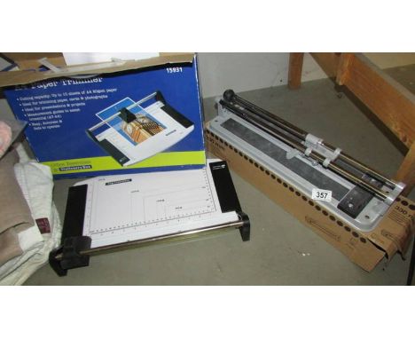 A boxed guillotine and a tile cutter.