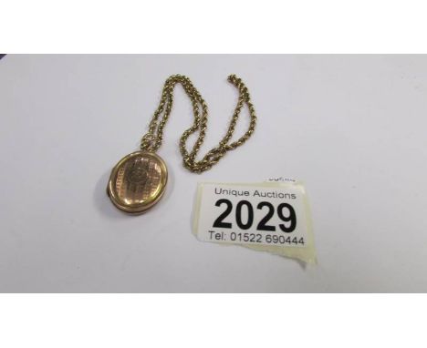 A rose gold 9ct back and front locket, engine turned on a 9ct gold chain, total weight 10.9 grams.