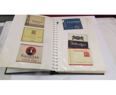 An album of vintage cigarette packets and 1920's New World gas cooker lithograph tin sign.