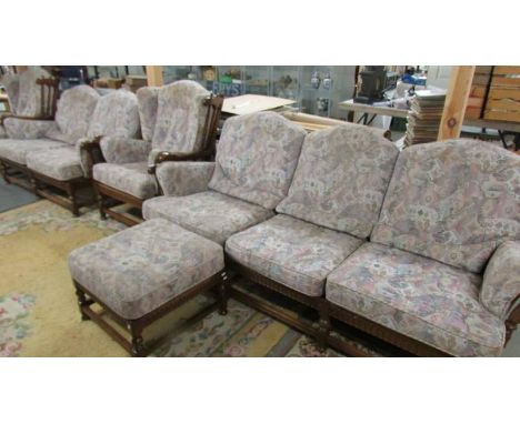 An Ercol five piece suite comprising 3 seat sofa, 2 seat sofa, 2 chairs and a stool.