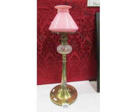 An arts and crafts oil lamp on brass base with glass font and pink glass shade (no chimney). ****Condition report**** The sha