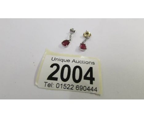A pair of 14ct white gold and ruby earrings.