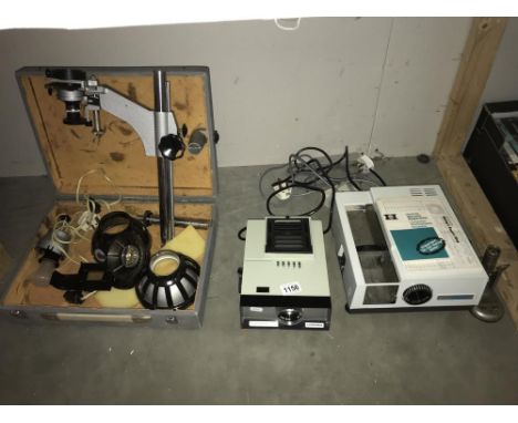 A cased Russian photo enlarger, Hanimex handrama slide projector and a Gnome supreme slide projector