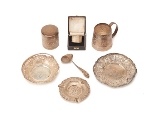 A GROUP OF INDONESIAN OR MALAYSIAN SILVER ITEMS
Comprising: a napkin ring, in a fitted case; a strainer spoon; a cylindrical 