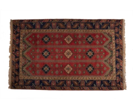 A TURKISH CARPET
Handmade, wool on wool, stylised geometric design on red ground
197cm high x 290cm wide
Condition: Minor sig