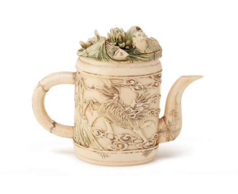 A MINIATURE CARVED IVORY TEAPOT
The body carved with a qilin, bamboo, peonies and birds, the cover with fish amongst waves an