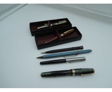 Three fountain pens, a boxed Pierre Farber ballpoint and two mechanical pencils. A Parker Vacumatic and a boxed Pierre Farber