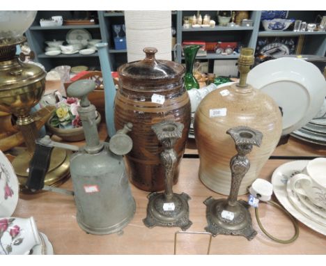 A selection of hardware including candle sticks and lamp base