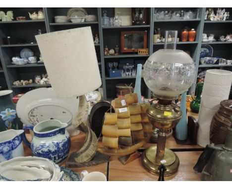 A selection of lights and lamps including animal horn and gasCONDITION REPORT oil lamp in good condition, over polished, a fe