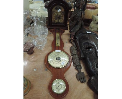 A bracket clock and similar barrometer
