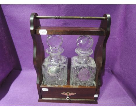 A tantalus and decanter set with whisky and gin label badgesCONDITION REPORT unmarked and in good condition, unknown type of 