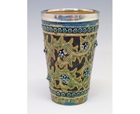 Doulton Lambeth stoneware beaker having stylised foliate decoration in relief on a mottled brown ground, base with impressed 